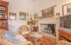 a living room with a television and a fireplace at Villa Esmeralda in Menfi