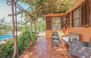a patio with a table and chairs next to a house at Villa Esmeralda in Menfi