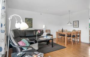 a living room with a couch and a table at One-Bedroom Holiday Home In Ribe in Mandø By