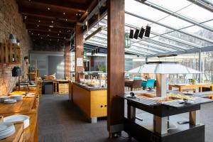 a restaurant with a table with food on it at Amenity Hotel & Resort Lipno in Lipno nad Vltavou