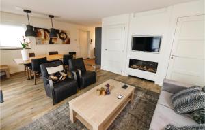 a living room with a couch and a fireplace at Bodelaeke-Rietburg Wellness 4P in Giethoorn +9 photos