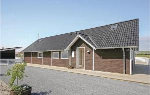 a large wooden house with a gambrel roof at Holiday Home Gloryvej Harboøre Iv in Harboør +21 photos