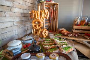 a buffet with sandwiches and pretzels and other food at Amenity Hotel & Resort Lipno in Lipno nad Vltavou