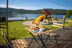 a picnic table with food on it with a playground at Amenity Hotel & Resort Lipno in Lipno nad Vltavou +37 photos