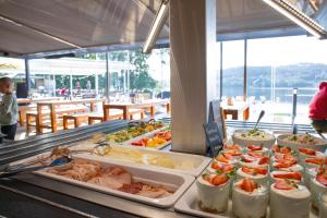 a buffet line with many different types of food at Amenity Hotel & Resort Lipno in Lipno nad Vltavou