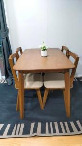 a wooden table with two chairs and a potted plant on it at Tanakorn House in Thong Nai Pan Yai +4 photos