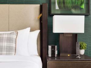a bedroom with a bed and a lamp on a night stand at Fairmont Banff Springs in Banff