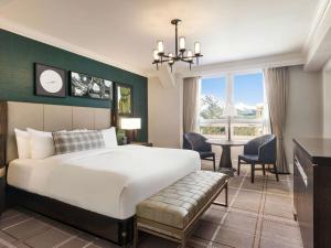 a bedroom with a large bed and a table with chairs at Fairmont Banff Springs in Banff