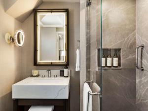 a bathroom with a sink and a shower with a mirror at Fairmont Banff Springs in Banff