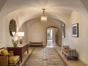 a hallway with a living room with a table and chairs at Fairmont Banff Springs in Banff