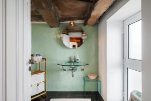 a bathroom with a glass table on a green wall at Quinta da Fonte in Prazeres +6 photos