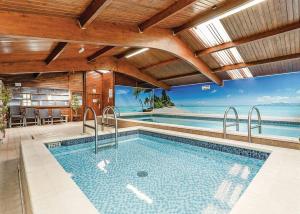 an indoor swimming pool with a view of the ocean at Bucklegrove Holiday Resort in Rodney Stoke