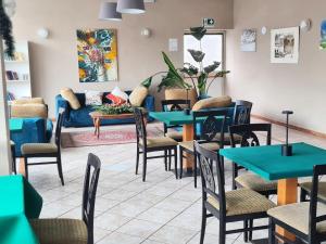 a restaurant with tables and chairs and a couch at Excelsior Hotel Cimone LowCost in San Martino di Castrozza
