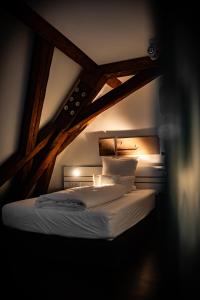 a bedroom with a bed in a dark room at Design Hotel & Restaurant Löwen in Ulm