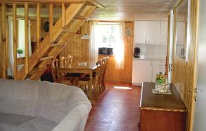 a living room with a couch and a table and a kitchen at Amazing Home In Ljungby With Wifi in Bolmstad