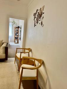 a living room with two chairs and a couch at Little White Heaven - shared apartment in Sydney