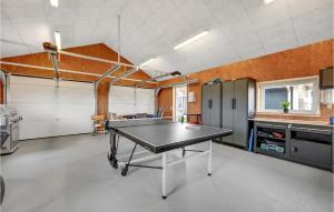 an empty garage with a ping pong table in it at Amazing Home In Thisted With Sauna in Sønder Vorupør +40 photos