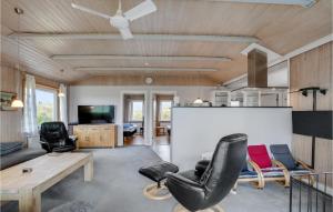 a living room with a table and chairs at Amazing Home In Thisted With Sauna in Sønder Vorupør