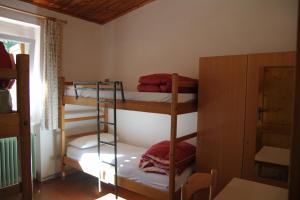 a room with three bunk beds and a window at Villaggio Santa Lucia in Ledro +16 photos
