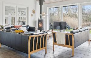 a living room with a couch and a tv at Nice Home In Vejby With Sauna in Vejby