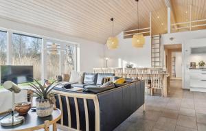 a living room with a couch and a table at Nice Home In Vejby With Sauna in Vejby +22 photos