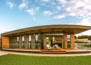 a building with a circular roof with a patio at Goosedale Lodges in Nottingham