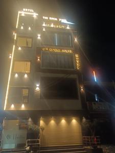 a building with lights on top of it at night at hotel the royal jewel in Hisār