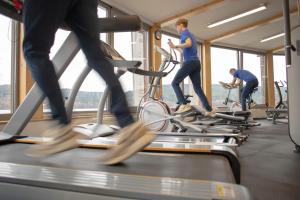 a group of people on bikes in a gym at Amenity Hotel & Resort Lipno in Lipno nad Vltavou