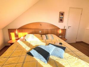 a bedroom with a large bed with a wooden headboard at Apartment Schwarzwaldblick III by Interhome in Bernau im Schwarzwald