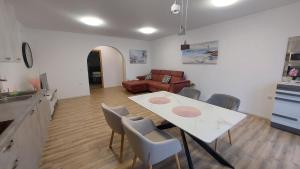 a kitchen and living room with a table and chairs at Apartment Modrić Zadar II in Zadar