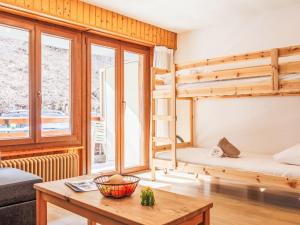 a room with two bunk beds and a table at Studio Quille du Diable 4 by Interhome in Nendaz