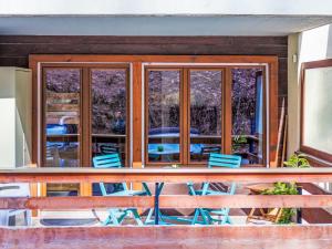 a screened in porch with chairs and a table at Studio Quille du Diable 4 by Interhome in Nendaz