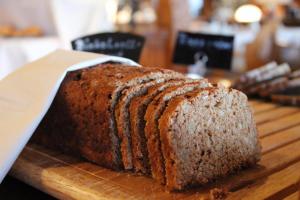 a loaf of bread sitting on a wooden cutting board at Hotel & Residence Hochriegel in Spiegelau