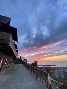 a view of the sunset from a balcony of a building at Loya Butik Otel Bungalov in Rize