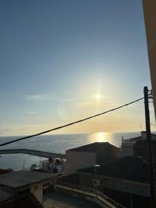 a view of the ocean at sunset from a building at Villa Rosa in Plomari +22 photos