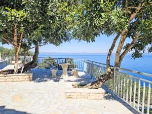 a walkway with trees next to the water at Holiday Home Brankovi Dvori by Interhome in Prigradica +34 photos
