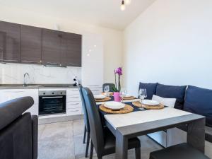 a kitchen and dining room with a table and chairs at Apartment Casa Clio by Interhome in Varazze