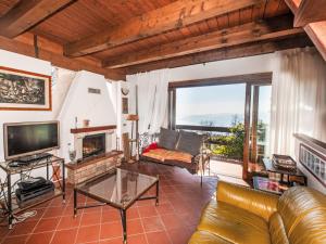a living room with a couch and a fireplace at Holiday Home Villa dei Pighi by Interhome in Premeno