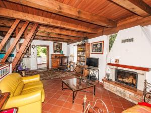 a living room with a yellow couch and a fireplace at Holiday Home Villa dei Pighi by Interhome in Premeno
