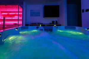 a large hot tub in a room with a tv at TESLA Residence Subotica in Subotica