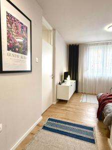 a bedroom with a bed and a desk with a picture on the wall at Studio Apartment 1906 in Mostar