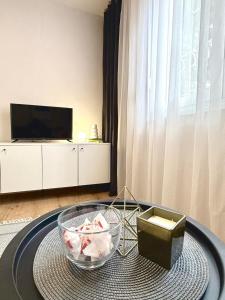 a living room with a table and a tv at Studio Apartment 1906 in Mostar