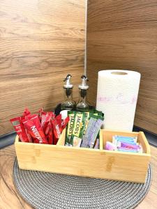 a wooden tray with two bottles and a roll of toilet paper at Studio Apartment 1906 in Mostar