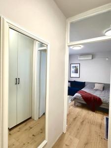 a mirror in a room with a bed and a bedroom at Studio Apartment 1906 in Mostar +2 photos