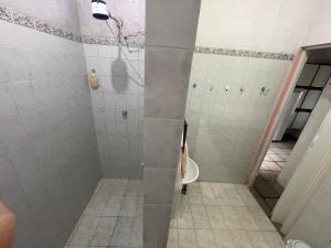 a bathroom with a shower with a toilet in it at Casa espaçosa e conectada com a natureza in Cananéia