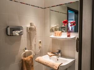 a bathroom with a sink and a mirror at Wetzlarer Hof Hotel & Restaurant in Wetzlar +77 photos