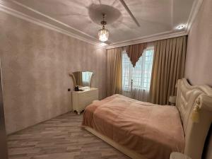 a bedroom with a bed and a window at Gabala Riverside House in Gabala