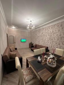 a living room with a dining table and a couch at Gabala Riverside House in Gabala +19 photos