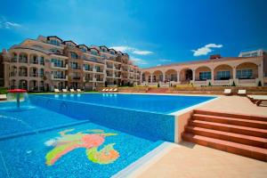 a swimming pool in front of a building at Sunset in Chernomorets