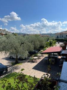 a view of a patio with tables and trees at Hotel Lory in Garda